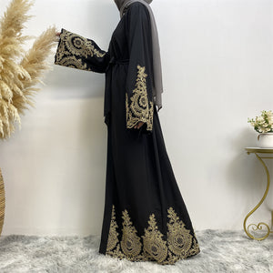 Side view of elegant gold lace border abaya