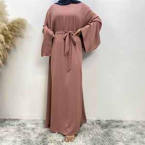 Front view of Hira abaya with elegant flow and pleated belt styling