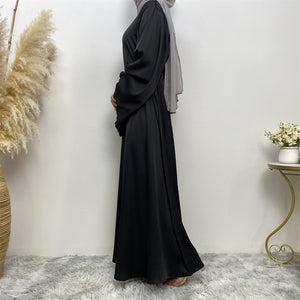 Side view of Hira satin abaya showing satin sheen and graceful drape