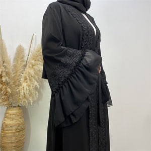 Close-up of lace trim on black chiffon ruffle abaya
