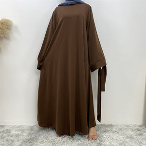 Front view of Hira abaya with elegant flow and pleated belt styling