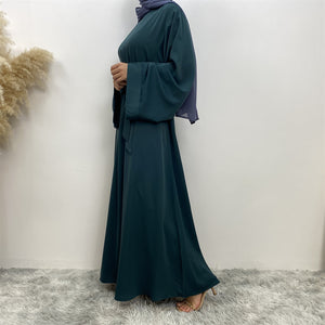 Side view of Hira abaya in nidha fabric showing modest flow
