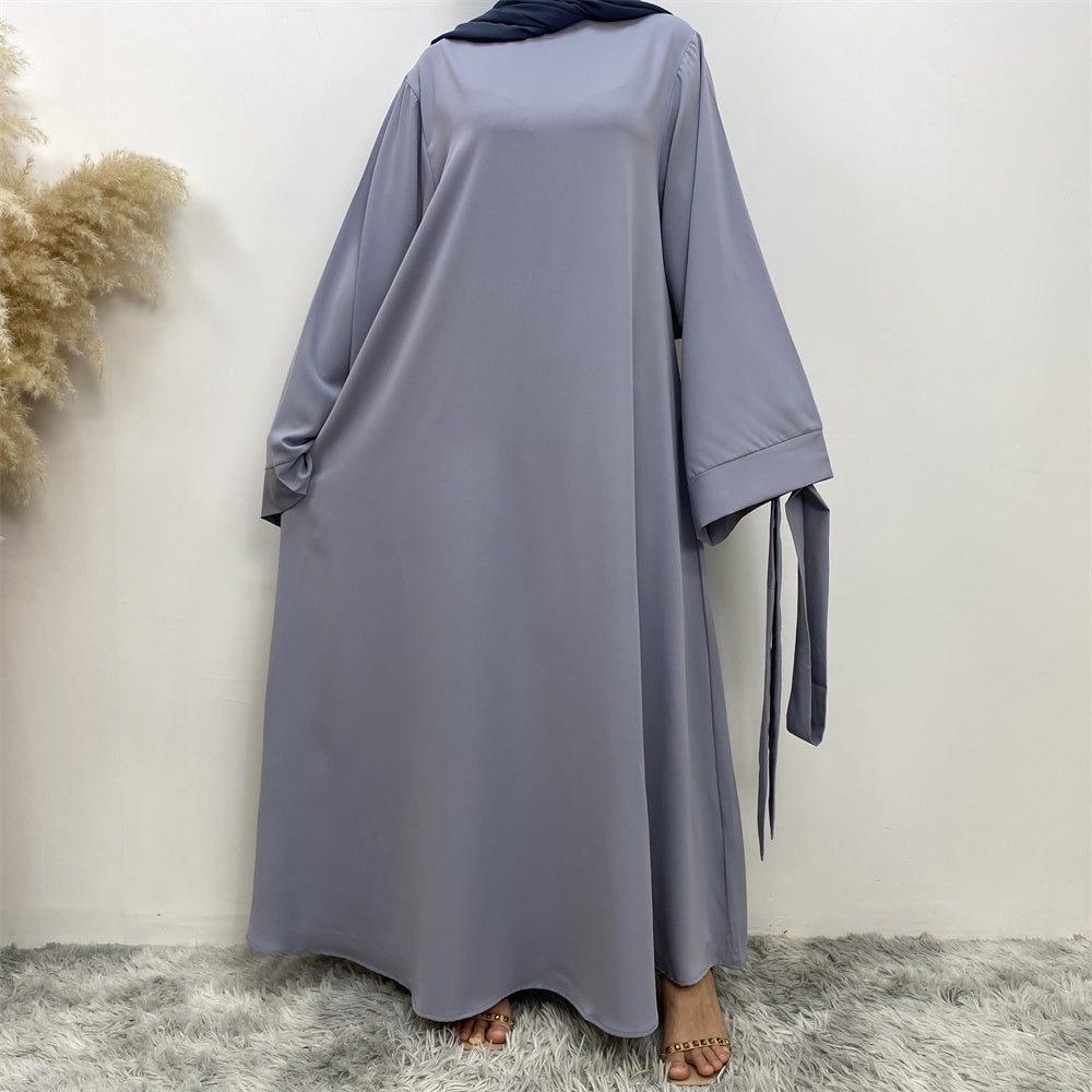 Front view of Hira abaya with elegant flow and pleated belt styling