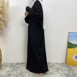 Side view of ribbed knit abaya coatigan with pockets