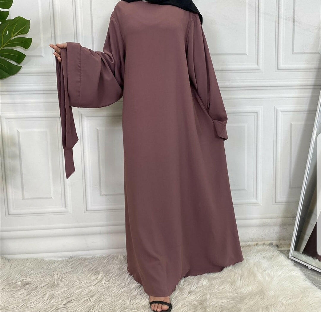 Front view of Hira abaya with elegant flow and pleated belt styling
