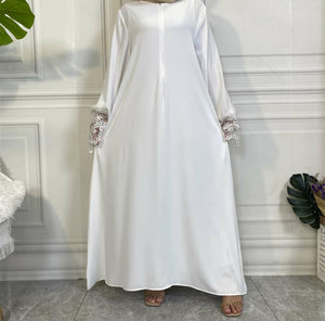 White Aira abaya with luxury lace trim sleeves and matching belt, crafted from premium nidha fabric.