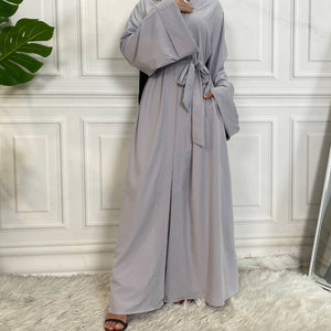 Front view of Dua open abaya with pockets, wide sleeves and graceful flow