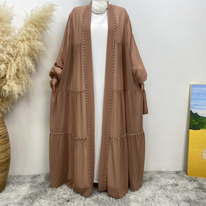 Front view of Gazala abaya with pearls, layered chiffon and matching belt
