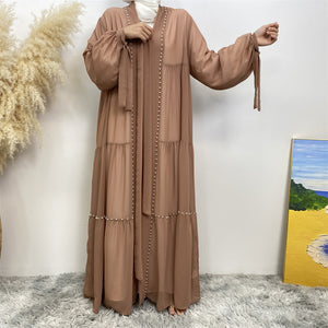 Front view of Gazala abaya with pearls, layered chiffon and matching belt