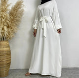 Front view of Dina abaya with belt, elegant pleats and wudhu-friendly sleeves