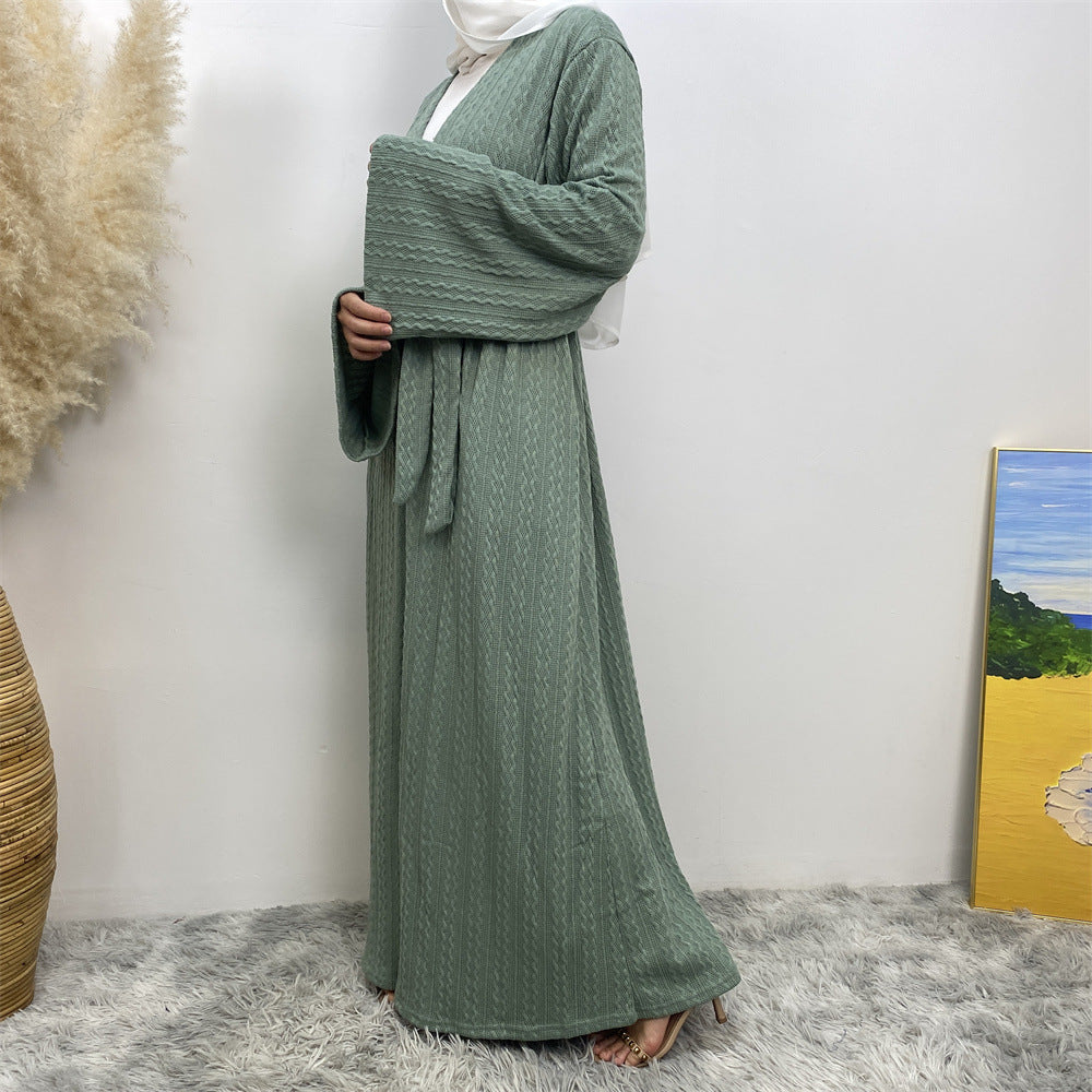 Side view of knitted winter coatigan with belt and pockets
