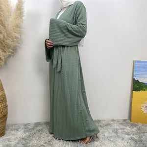 Side view of knitted winter coatigan with belt and pockets