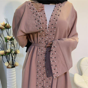 Close-up of pearl embellishments on scalloped sleeve abaya
