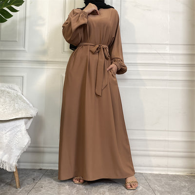 Front view of Dina abaya with belt, elegant pleats and wudhu-friendly sleeves