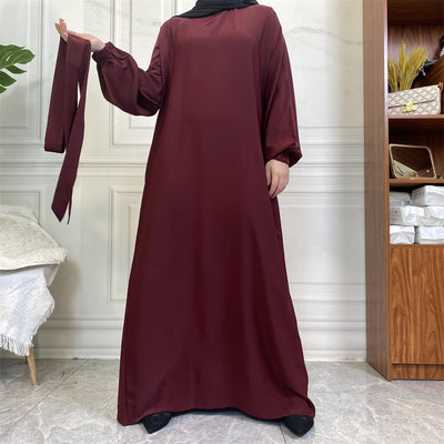 Front view of Dina abaya with belt, elegant pleats and wudhu-friendly sleeves